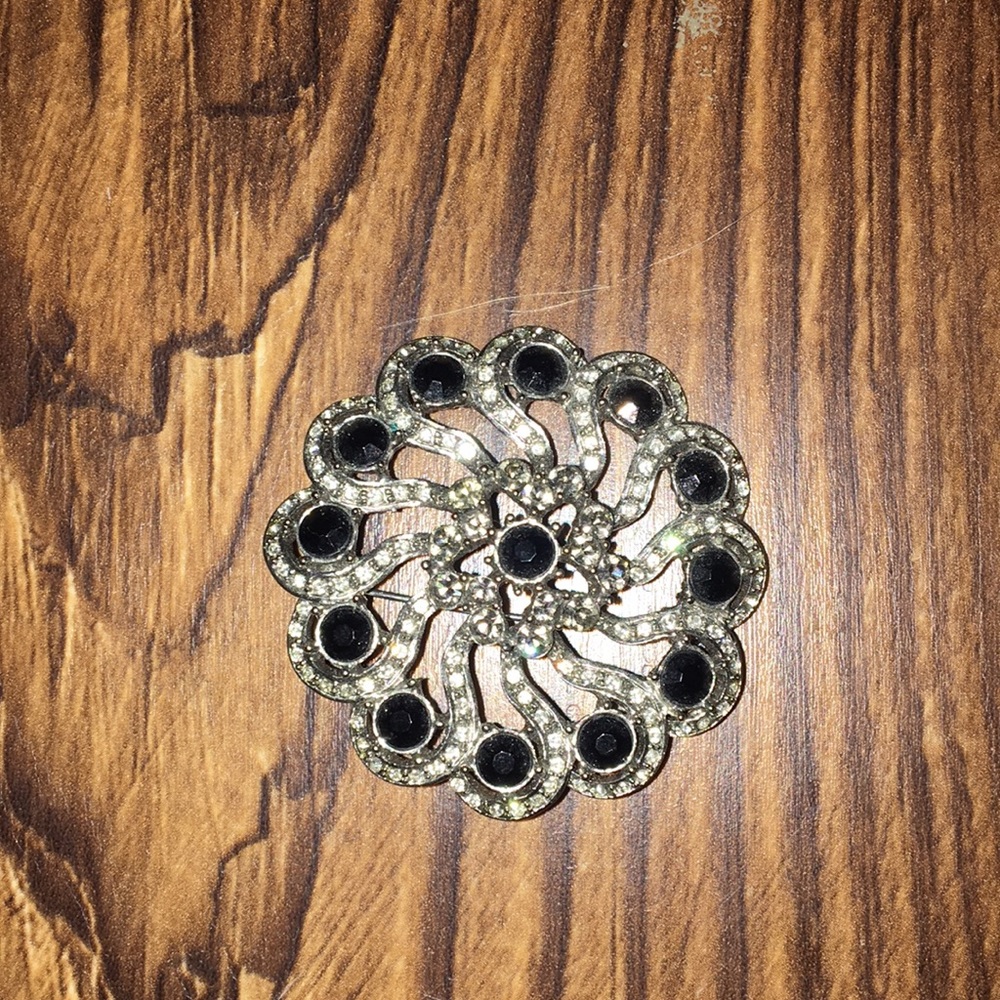 Black and silver brooch